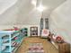Cozy attic room featuring built-in shelves, a comfortable armchair, and decorative accents for versatile use at 1138 N Oxford St, Indianapolis, IN 46201