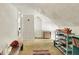 Angled attic space with white walls, vintage furniture, and unique decor offering character and storage potential at 1138 N Oxford St, Indianapolis, IN 46201
