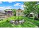 Relaxing backyard featuring a cozy firepit area with stone benches, ideal for outdoor gatherings at 1138 N Oxford St, Indianapolis, IN 46201