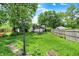 Backyard featuring a vintage street lamp, outbuildings, and lush green surroundings at 1138 N Oxford St, Indianapolis, IN 46201