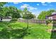Fenced-in backyard, blending privacy with a spacious lawn and mature trees at 1138 N Oxford St, Indianapolis, IN 46201