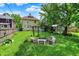 Large backyard with a fire pit, stone benches and garden, perfect for enjoying outdoor living at 1138 N Oxford St, Indianapolis, IN 46201