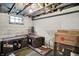 Clean utility basement featuring storage trunks, concrete walls, and a window providing natural light at 1138 N Oxford St, Indianapolis, IN 46201