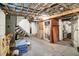 Unfinished basement with exposed ceiling, concrete floor, and potential for customization at 1138 N Oxford St, Indianapolis, IN 46201