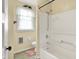 Standard bathroom featuring a shower-tub combo and window at 1138 N Oxford St, Indianapolis, IN 46201
