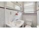 Bathroom with a sink, toilet, mirror, and patterned wallpaper at 1138 N Oxford St, Indianapolis, IN 46201