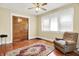 Bedroom with a comfy chair, ample natural light, and wooden floors at 1138 N Oxford St, Indianapolis, IN 46201