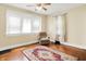 Cozy bedroom featuring hardwood floors, a ceiling fan, and natural light from large windows at 1138 N Oxford St, Indianapolis, IN 46201