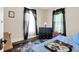 Relaxing bedroom featuring a comfortable bed, dark curtains, and a dragon-themed rug at 1138 N Oxford St, Indianapolis, IN 46201
