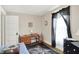 Well-lit bedroom with a wood desk, black dresser, and dragon-themed rug at 1138 N Oxford St, Indianapolis, IN 46201
