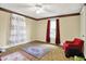 Cozy bedroom featuring patterned wallpaper, ceiling fan and vintage-style furnishings at 1138 N Oxford St, Indianapolis, IN 46201