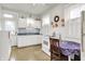 Cozy kitchen with white cabinets, tile backsplash, and a small table with chairs at 1138 N Oxford St, Indianapolis, IN 46201
