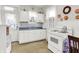 Kitchen featuring white cabinets and appliances, complemented by a tile floor and natural light at 1138 N Oxford St, Indianapolis, IN 46201