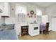 Kitchen featuring white cabinets and appliances, complemented by a tile floor and natural light at 1138 N Oxford St, Indianapolis, IN 46201