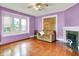 Spacious living room featuring a decorative fireplace, hardwood floors, and ample natural light, perfect for entertaining at 1138 N Oxford St, Indianapolis, IN 46201