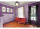 Charming living room featuring stained glass windows, hardwood floors, and tasteful decor, creating a cozy atmosphere at 1138 N Oxford St, Indianapolis, IN 46201