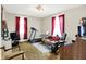Multi-purpose living room with home gym equipment, television, and adjacent seating area at 1138 N Oxford St, Indianapolis, IN 46201