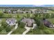 Aerial view of the golf course, multiple homes, and a very lush landscape at 11404 Hanbury Manor Blvd, Noblesville, IN 46060