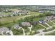 A picturesque aerial view of multiple homes, golf course, and swimming pool at 11404 Hanbury Manor Blvd, Noblesville, IN 46060