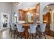Home bar featuring wood paneling, pendant lighting, and seating for five at 11404 Hanbury Manor Blvd, Noblesville, IN 46060