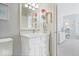 Well-lit bathroom featuring a white vanity with creative floral wall decor and hallway entrance at 11404 Hanbury Manor Blvd, Noblesville, IN 46060