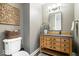 Cozy powder room with an earthy toned vanity, basket, and decorated wall art at 11404 Hanbury Manor Blvd, Noblesville, IN 46060