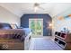 Charming bedroom with a blue accent wall and backyard access at 11404 Hanbury Manor Blvd, Noblesville, IN 46060