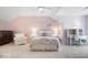Charming bedroom in soft hues features a plush bed, desk, and seating area at 11404 Hanbury Manor Blvd, Noblesville, IN 46060