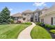 Stunning home featuring meticulous landscaping, a stone walkway, and large windows at 11404 Hanbury Manor Blvd, Noblesville, IN 46060
