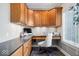 Inviting home office features custom built-in cabinetry, desk, and a comfortable chair at 11404 Hanbury Manor Blvd, Noblesville, IN 46060