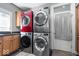 Bright laundry room features stacked washer and dryer, and custom cabinetry with a convenient utility sink at 11404 Hanbury Manor Blvd, Noblesville, IN 46060