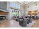 Open living room featuring high ceilings, a stone fireplace, and comfortable seating at 11404 Hanbury Manor Blvd, Noblesville, IN 46060