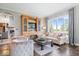 Elegant living room with a large window, hardwood floors, and cozy seating arrangement at 11404 Hanbury Manor Blvd, Noblesville, IN 46060