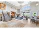 Open-concept living room with high ceilings, fireplace, and large windows at 11404 Hanbury Manor Blvd, Noblesville, IN 46060