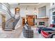 Open living space with a fireplace, wooden built-ins, and tall windows at 11404 Hanbury Manor Blvd, Noblesville, IN 46060