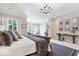 Tranquil main bedroom with a fireplace, sitting area, and large windows offering natural light at 11404 Hanbury Manor Blvd, Noblesville, IN 46060