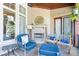Inviting covered patio with a stone fireplace and comfortable seating, ideal for outdoor living at 11404 Hanbury Manor Blvd, Noblesville, IN 46060