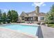 Stunning backyard pool with plenty of seating, a beautifully landscaped yard, and house view at 11404 Hanbury Manor Blvd, Noblesville, IN 46060