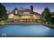 Backyard with a sparkling pool, patio with seating, and manicured landscaping at 11404 Hanbury Manor Blvd, Noblesville, IN 46060