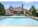 Backyard swimming pool with deck, seating and house view at 11404 Hanbury Manor Blvd, Noblesville, IN 46060