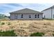 The backyard has a charming gray single-story house with neatly placed windows and a door for easy access at 1170 Mcbride St, Greenfield, IN 46140