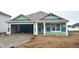 Exterior home during construction featuring open garage and covered porch, ready for customization and future memories at 1170 Mcbride St, Greenfield, IN 46140