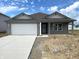 Charming single-story home with a gray exterior, a pristine white garage door, and a concrete driveway at 1170 Mcbride St, Greenfield, IN 46140