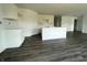 Bright kitchen featuring sleek gray hardwood floors and unfinished cabinets, ready for customization and your personal touch at 1170 Mcbride St, Greenfield, IN 46140