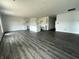 Spacious open-concept featuring gray hardwood floors and unfinished white cabinets, awaiting personalization at 1170 Mcbride St, Greenfield, IN 46140