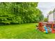 A large backyard with a deck, great for gatherings, and a lush green lawn extending to a tree line at 11919 Gatwick View Dr, Fishers, IN 46037