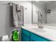 Cozy bathroom featuring a teal vanity, decorative mirror, and urinal at 11919 Gatwick View Dr, Fishers, IN 46037