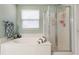 Bright bathroom featuring a tub, shower, and lots of natural light at 11919 Gatwick View Dr, Fishers, IN 46037
