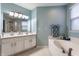 Well-lit bathroom featuring a tub, shower, and double sink vanity at 11919 Gatwick View Dr, Fishers, IN 46037