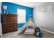 Playful room featuring bright blue walls, a teepee, and stuffed animals at 11919 Gatwick View Dr, Fishers, IN 46037